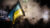 A Ukranian flag being flown during a night protest